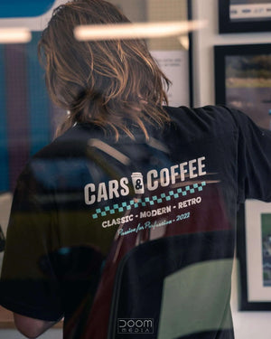 Cars and coffee logo on black t shirt - back view person wearing