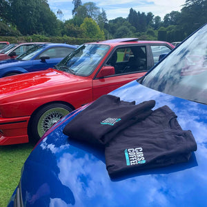 Cars and coffee t shirt on the bonnet of a car
